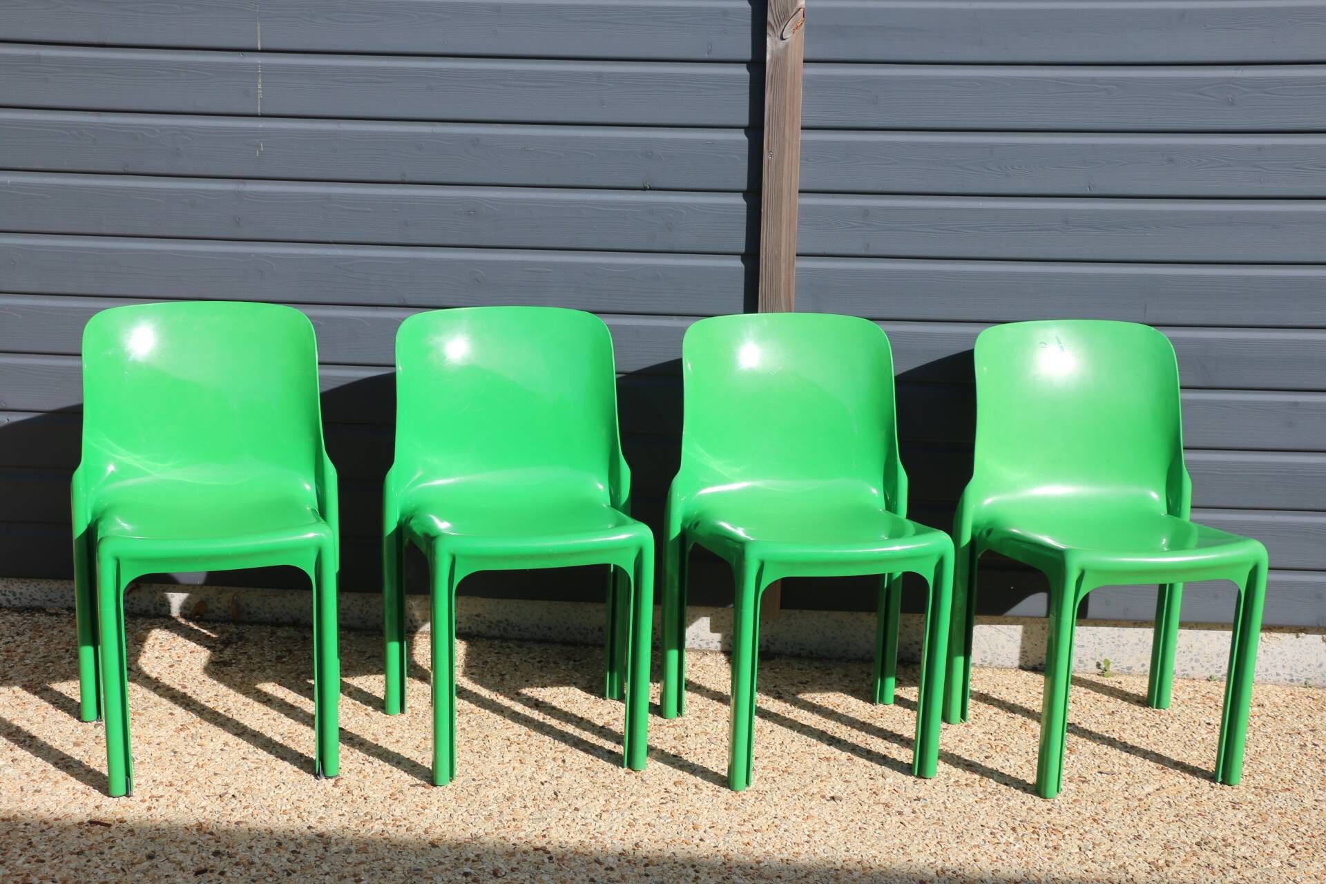 Set of 4 green Selene Magistretti chairs.