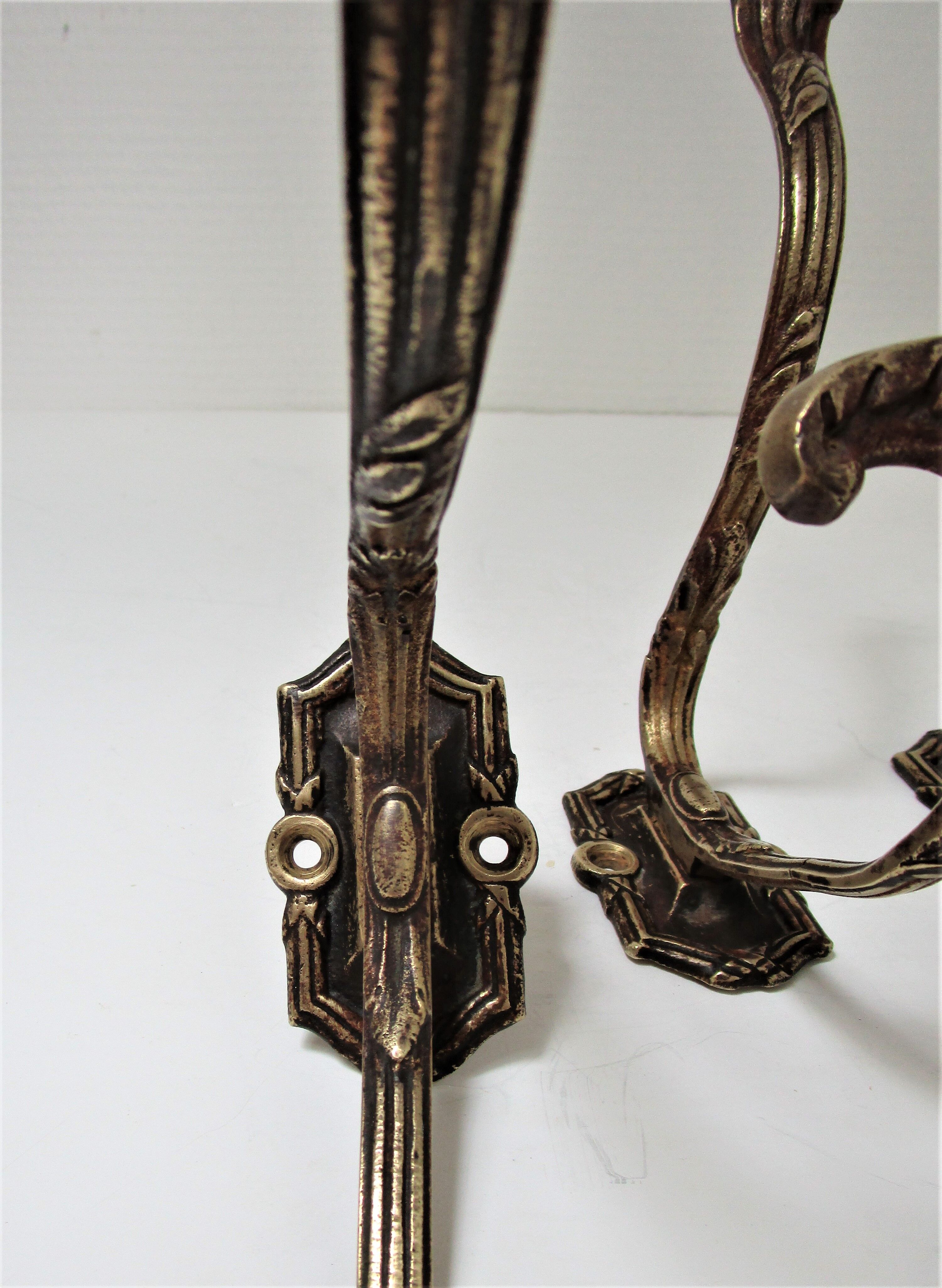 Four patères bronze patinated leafy décor early 20th century