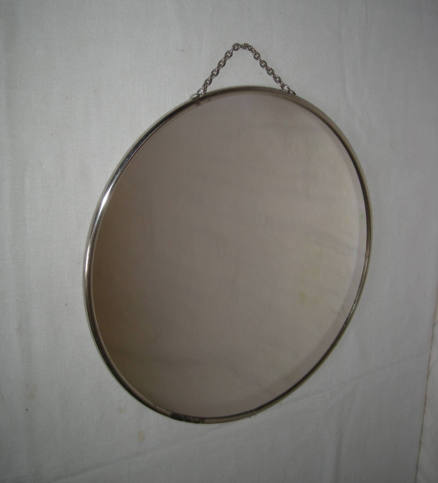 Round barber mirror with chain from the 1950s.