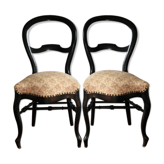 Black wooden chairs and floral fabric