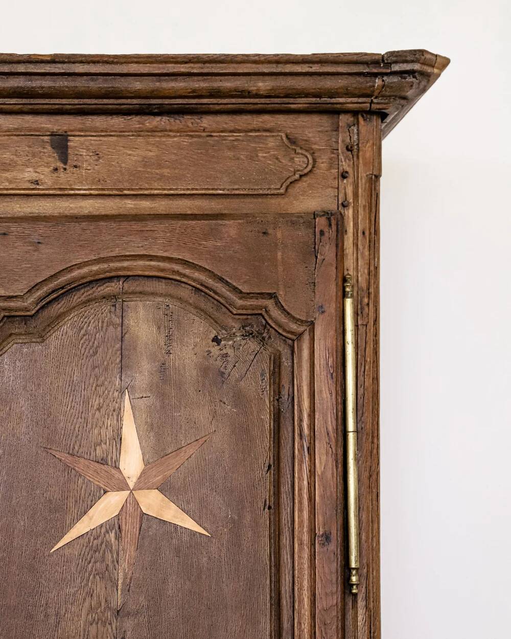 Antique French rustic wardrobe with star inlays.
