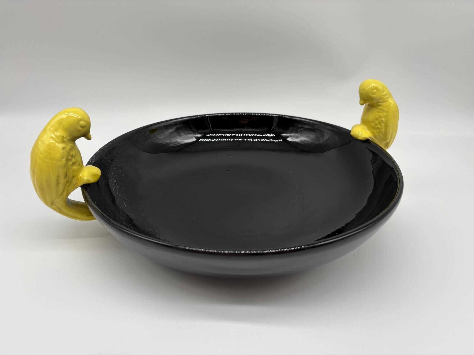 Large vintage black ceramic bowl with yellow parakeets, Vallauris.