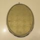 Old wall frame in carved wood and gilded stucco, oval