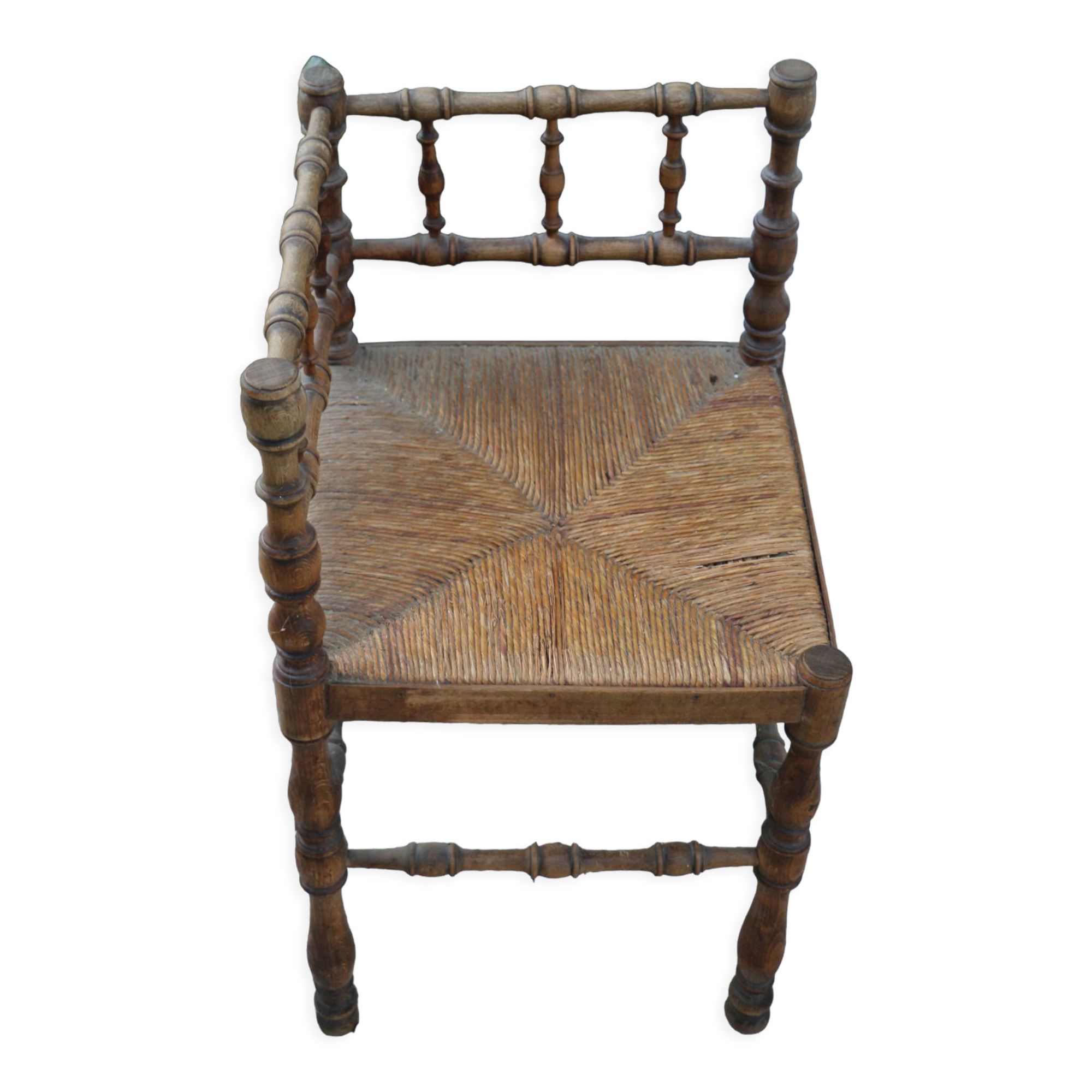 Antique corner chair in wood bamboo style seated in straw
