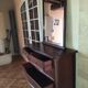 Style set: bevelled mirror and curved wooden chest of drawers.