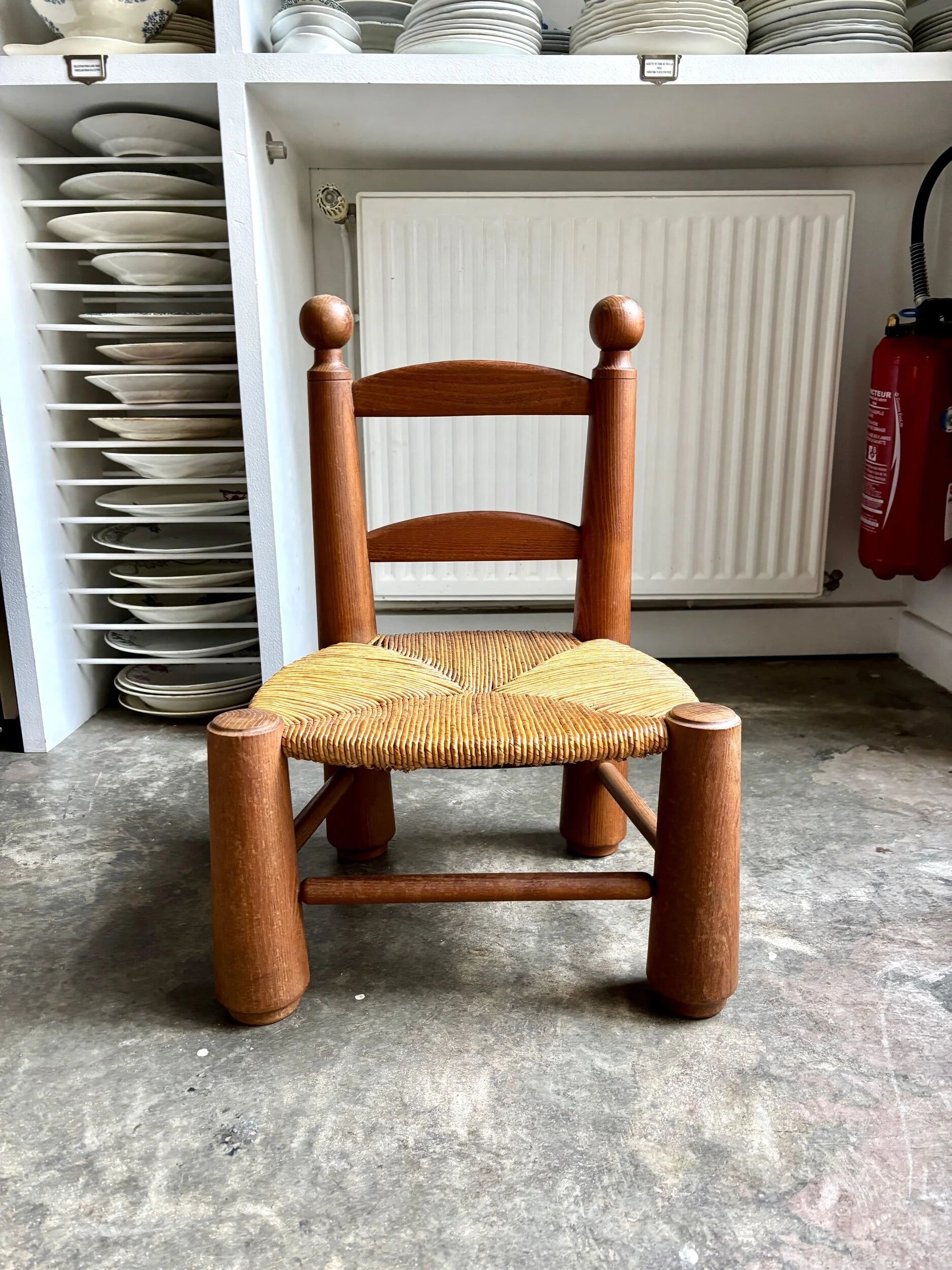 Brutalist low chair in dark wood and straw no. 3