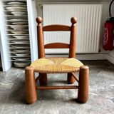 Brutalist low chair in dark wood and straw no. 3