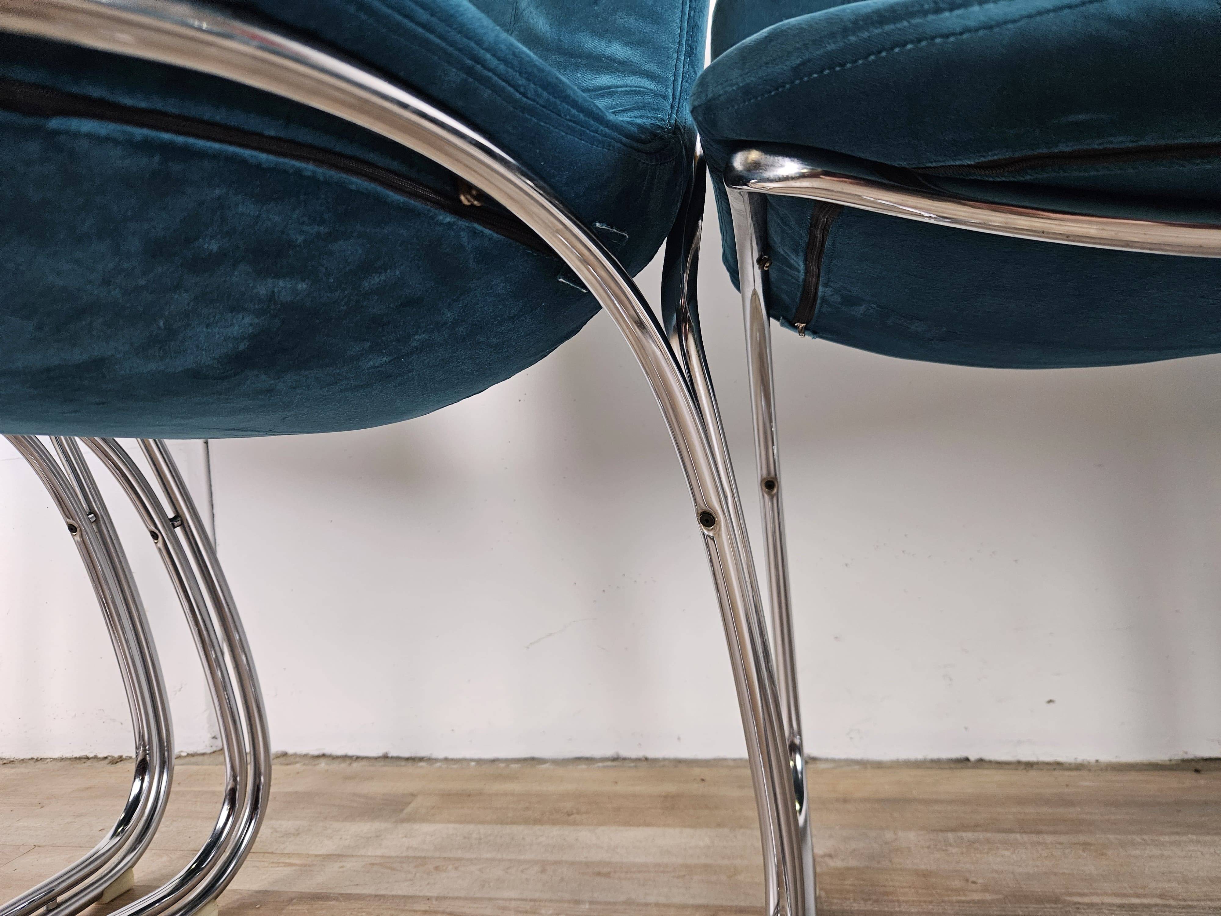 Four 1970s tubular chairs upholstered in blue velvet