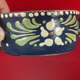 Small covered terracotta pot enamelled savoie or alsace flowers on a blue background