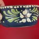 Small covered terracotta pot enamelled savoie or alsace flowers on a blue background