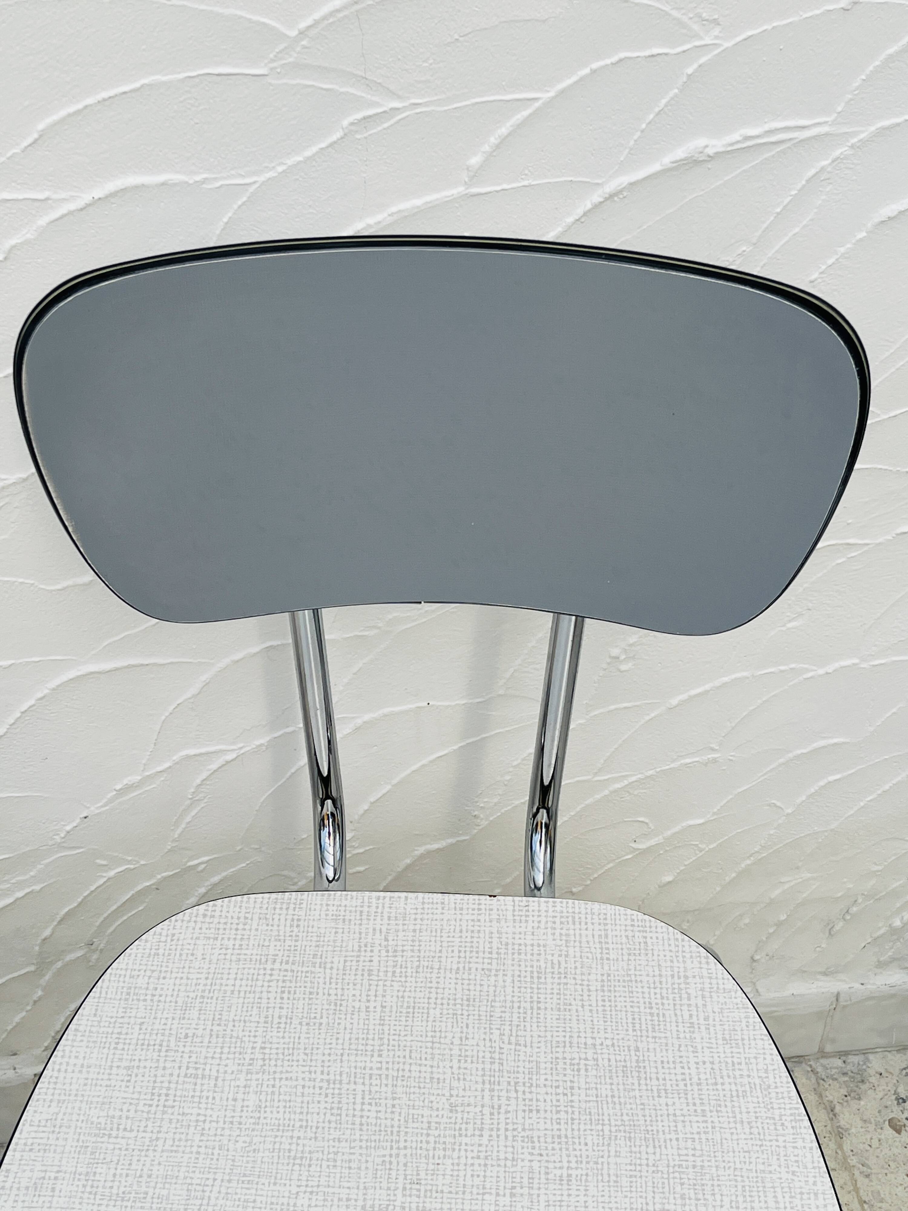 Set of two vintage grey Formica and chrome chairs.