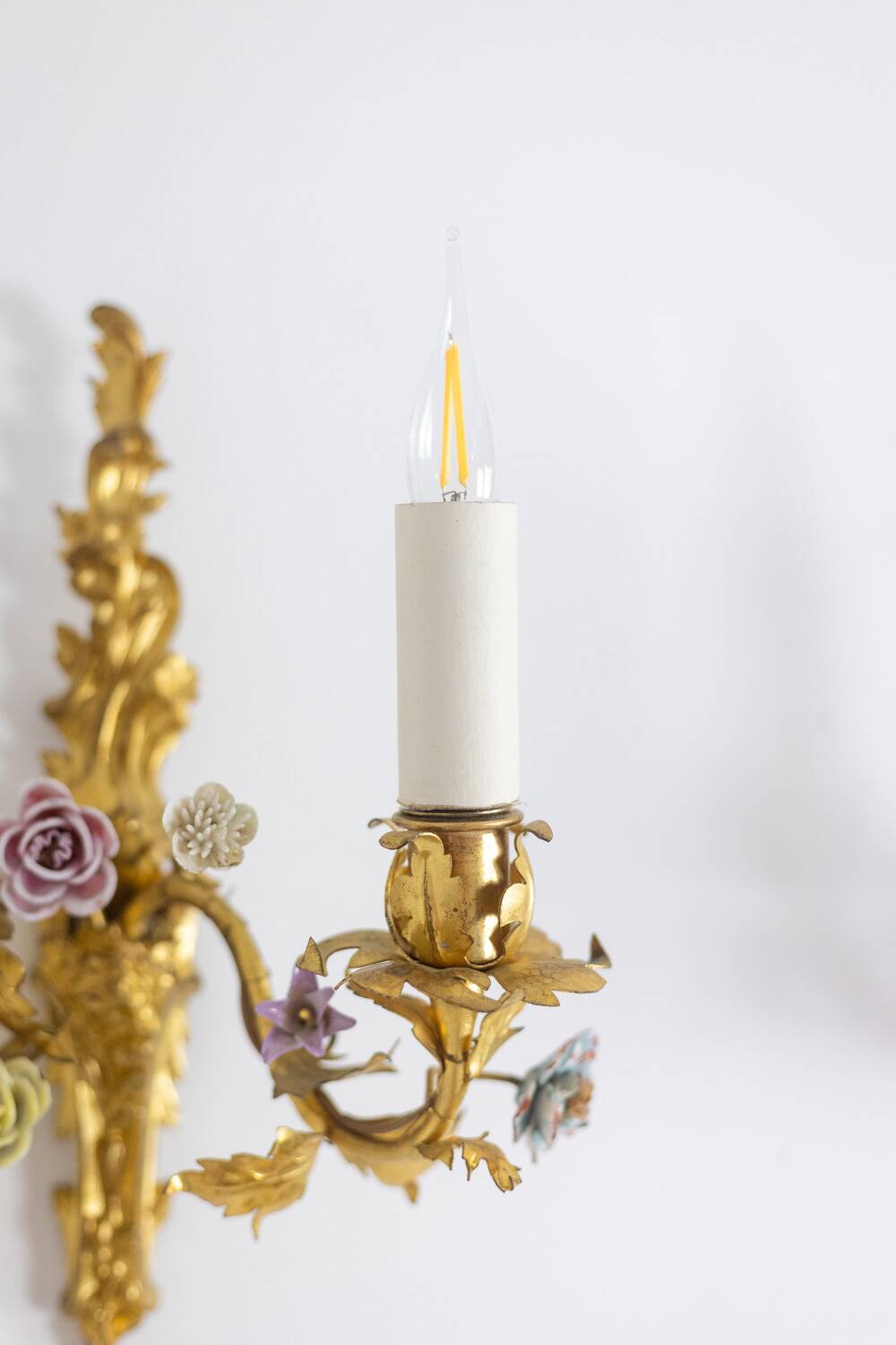 Pair of bronze wall lights with flower decoration. Circa 1880.