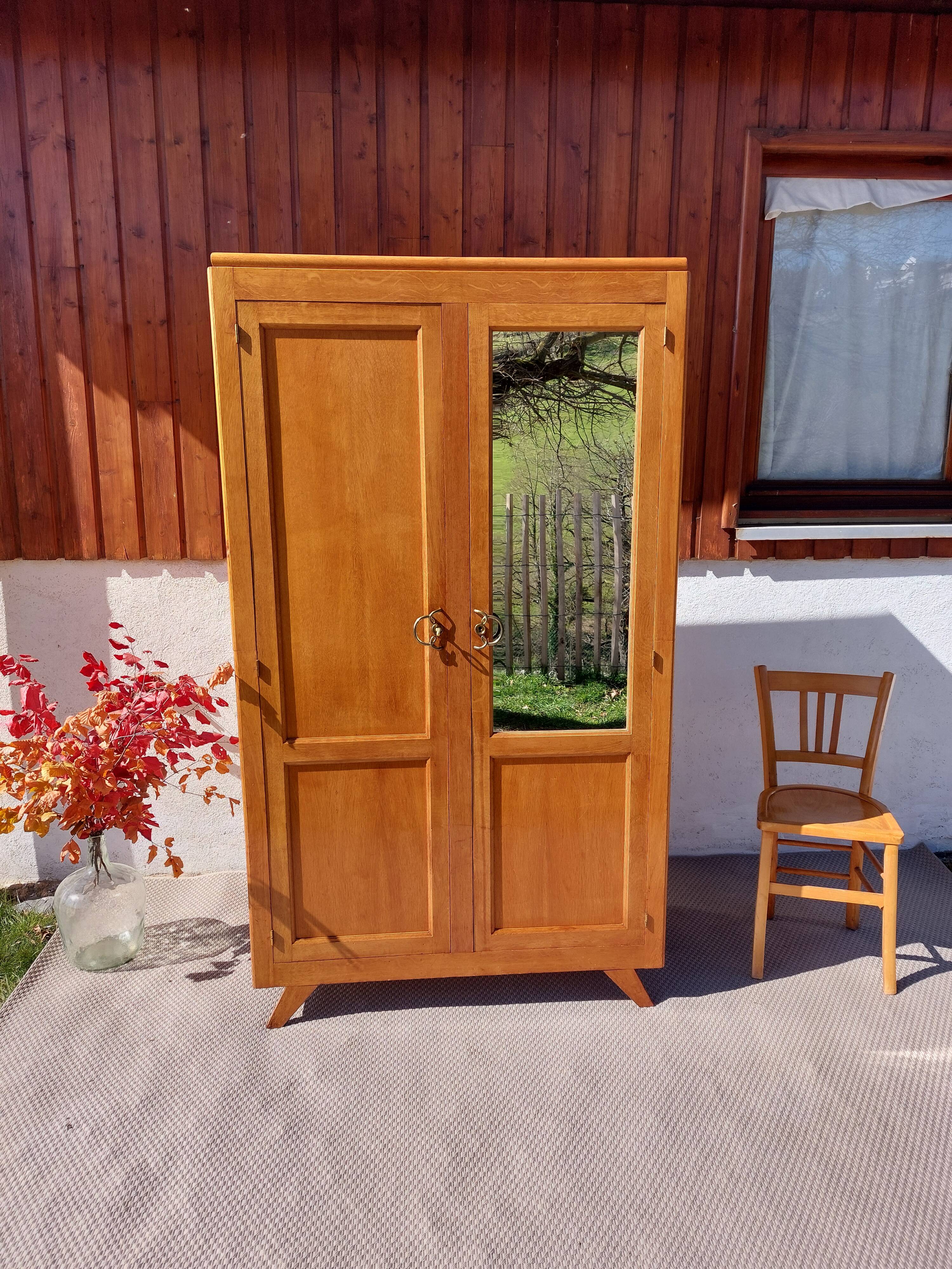 Vintage wardrobe with mirror and tapered legs.