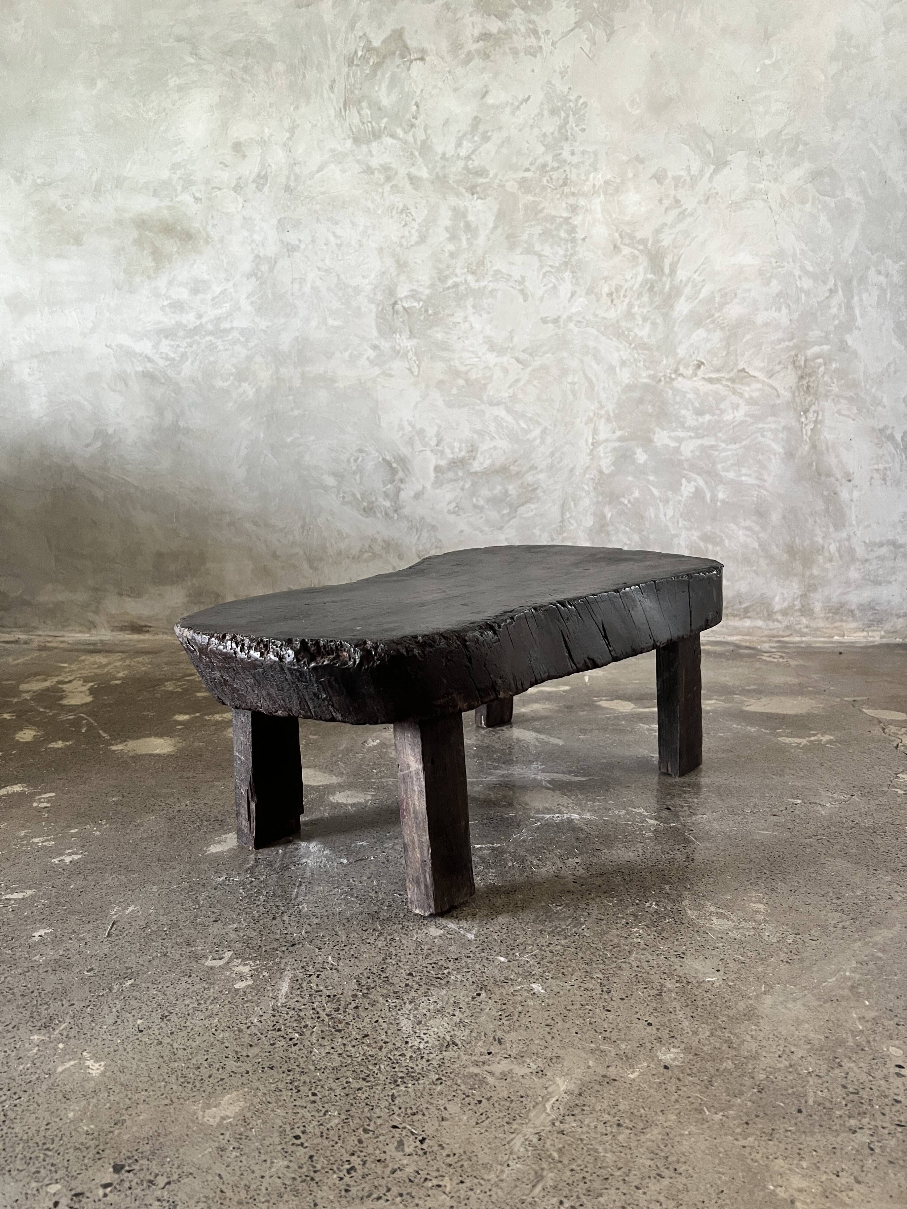 Small old Asian wooden coffee table in Japanese style, kidney-shaped top