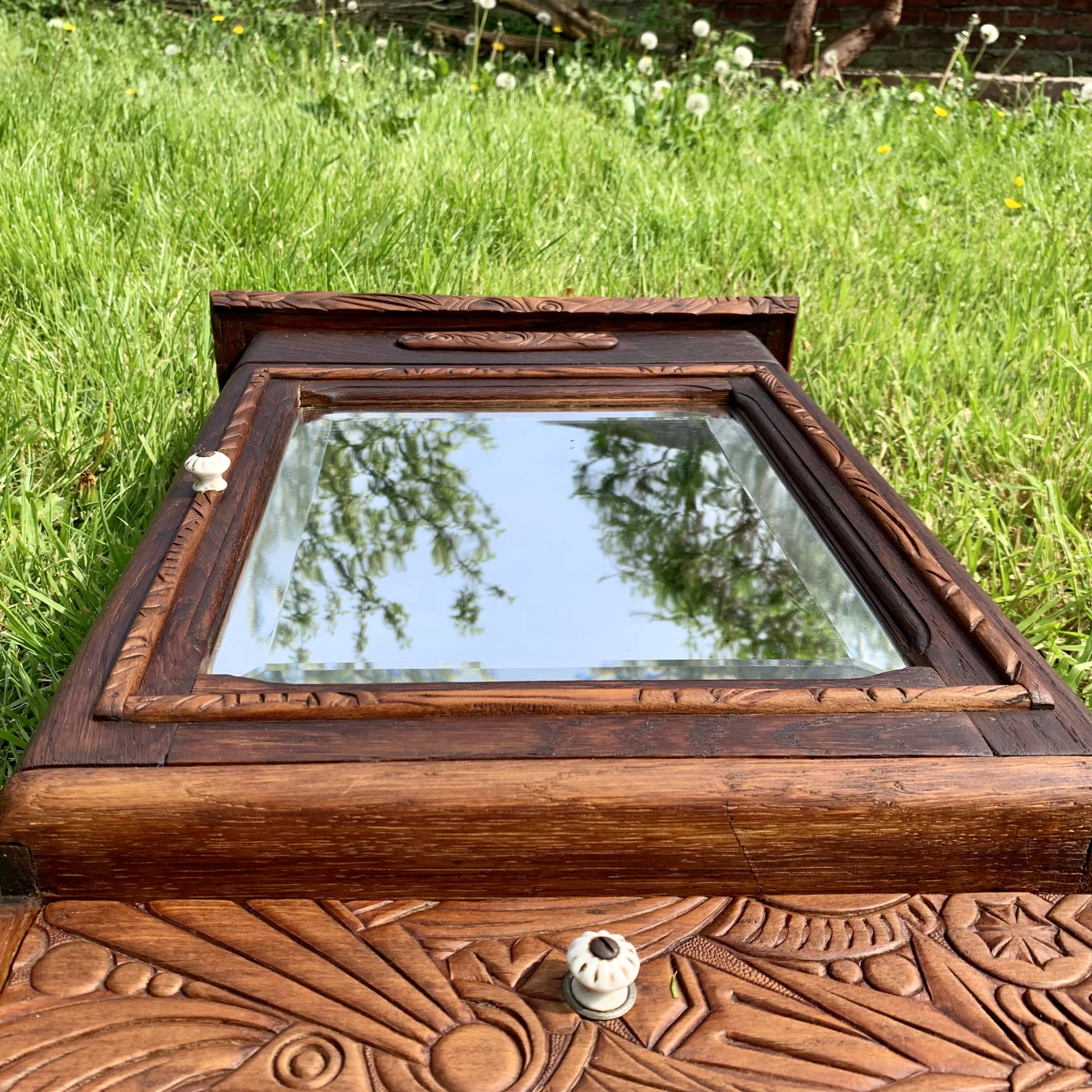 Old carved wooden medicine cabinet with beveled mirror