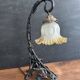 Art Nouveau wall light in wrought iron with vine decoration, early 20th century.