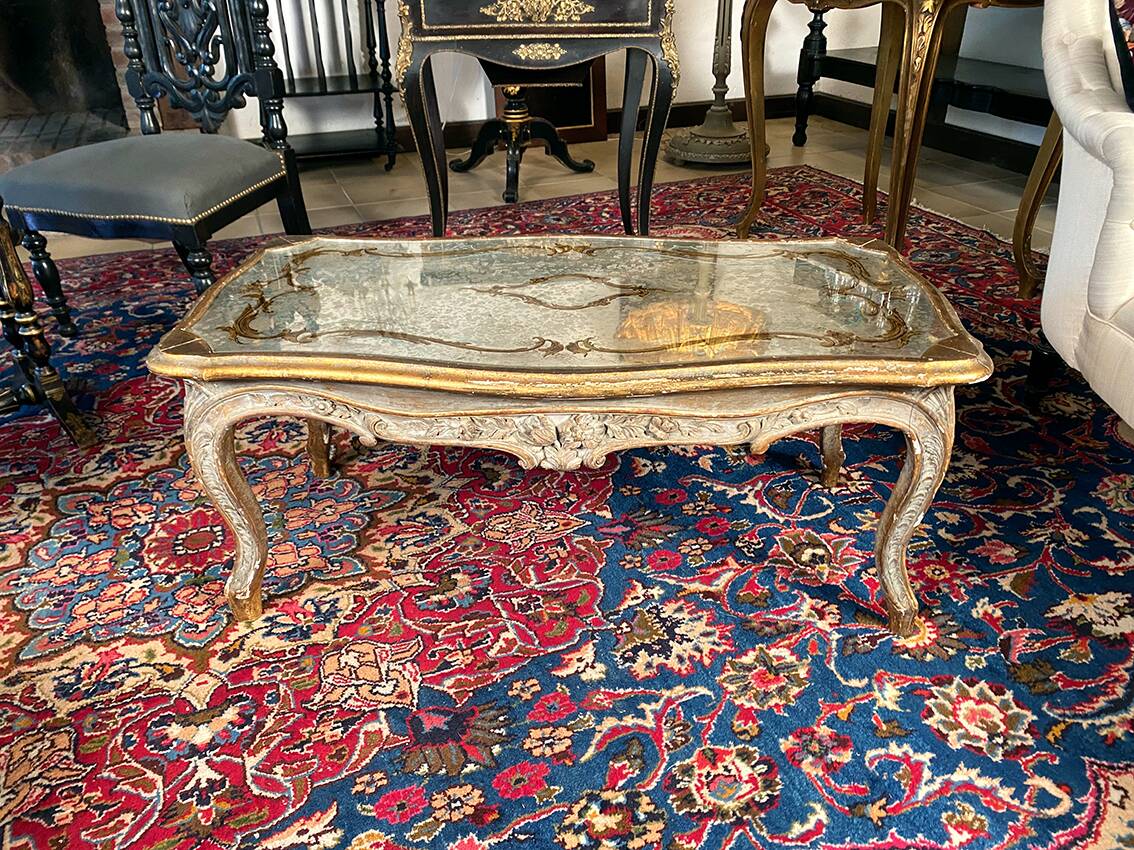 Louis XV style coffee table in carved wood with grey and gold highlights.