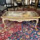 Louis XV style coffee table in carved wood with grey and gold highlights.