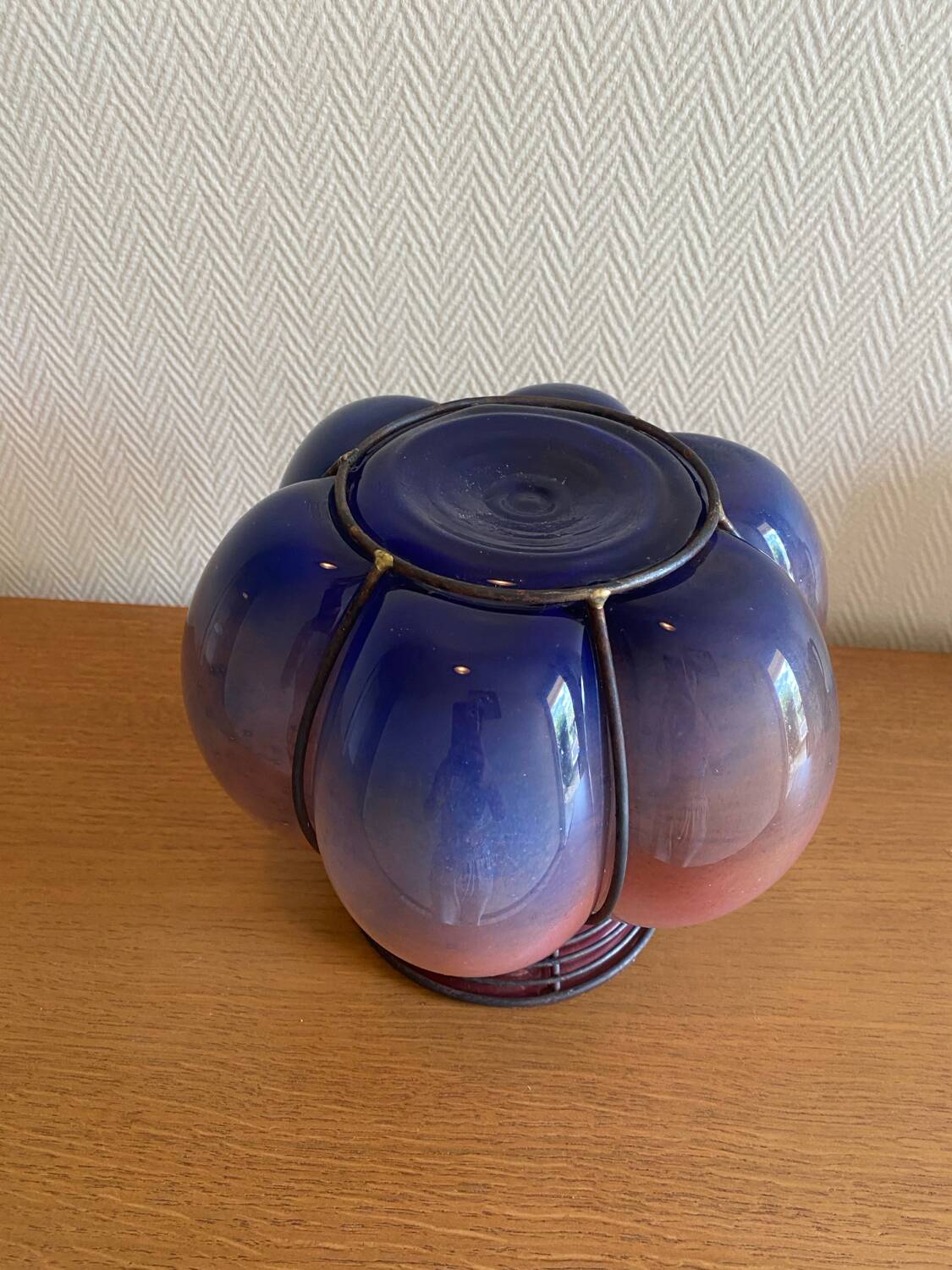 Blown glass vase with metal cage