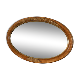 Ancien miroir ovale biseauté en bois doré et sculpté