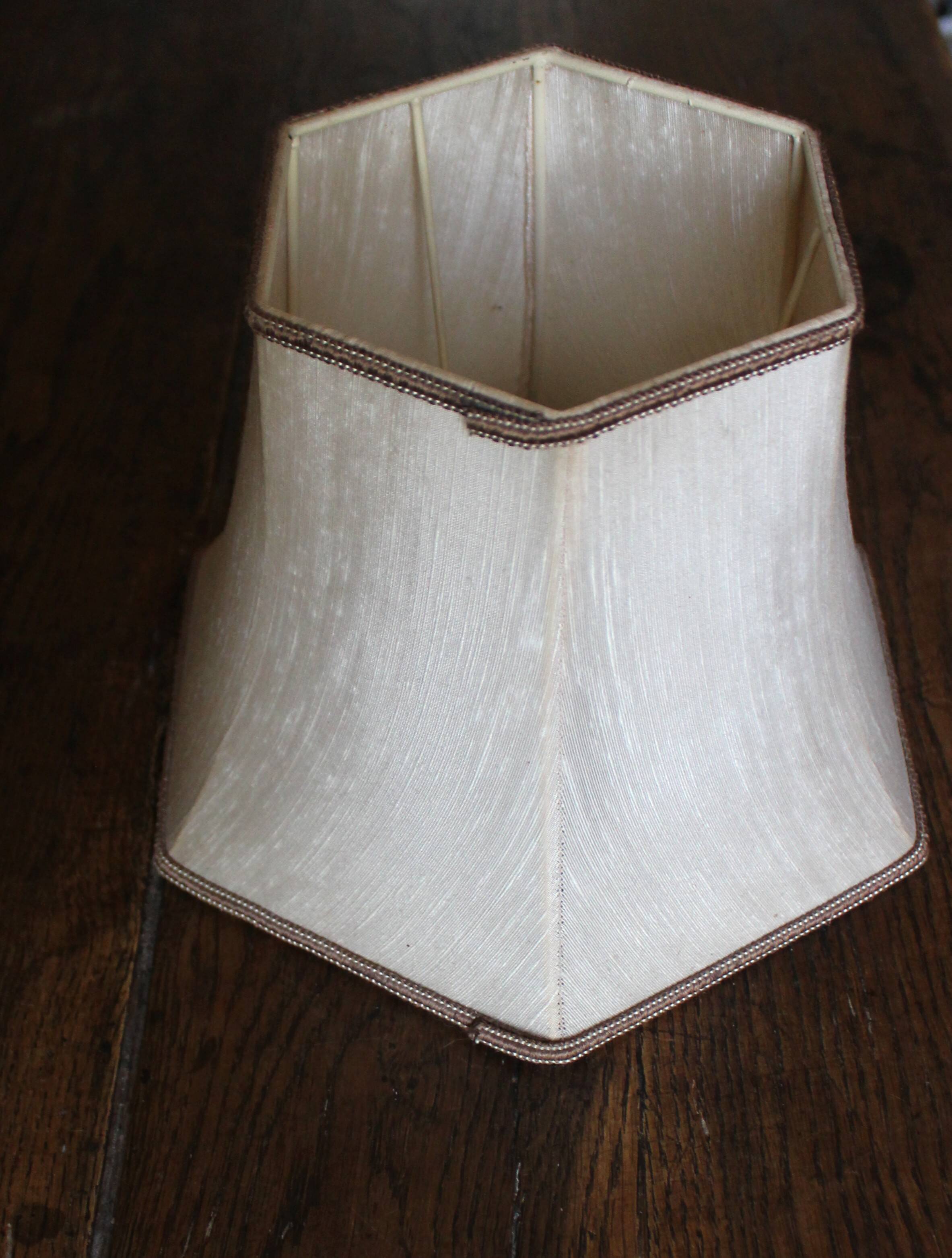 Table lamp with a patinated base and vintage woven shade.