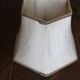 Table lamp with a patinated base and vintage woven shade.