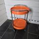 Orange trolley on wheels from the 70s