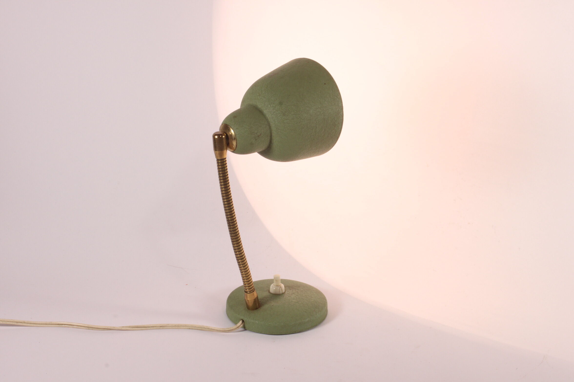 Flexible brass and green metal bedside lamp, 1950s.