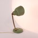 Flexible brass and green metal bedside lamp, 1950s.