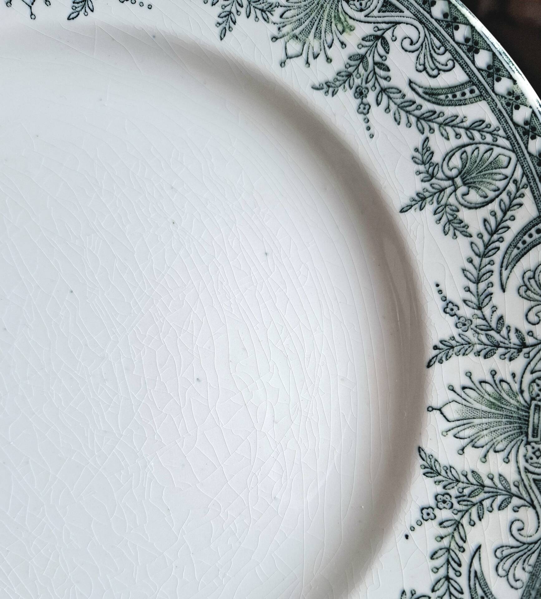 Old mismatched flat plates made of ironstone earthenware.