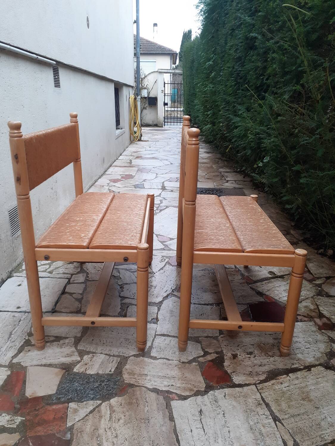 2 wooden and straw benches