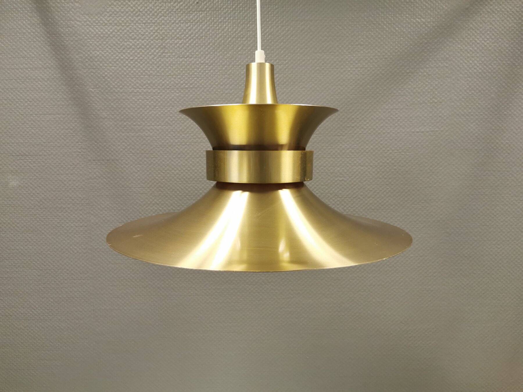 Large hanging lamp, made of brass-coloured aluminium with red and white contrast lacquer inside.