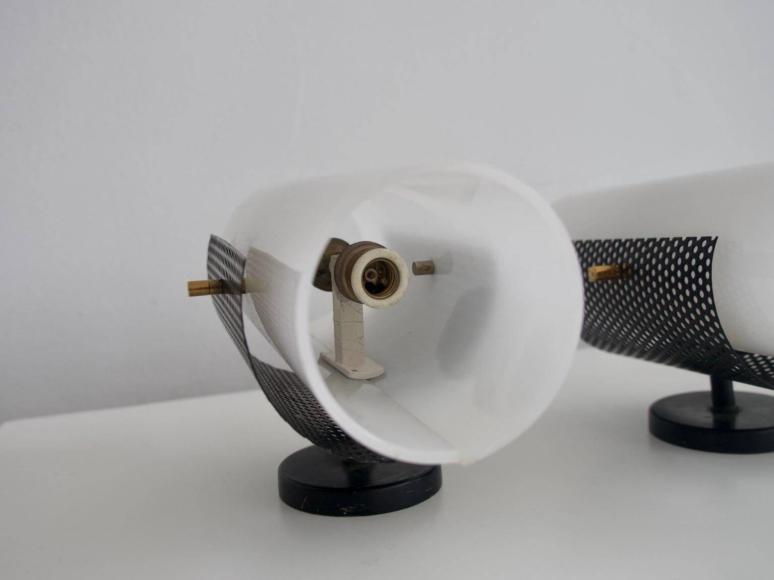 Set of four wall lights in white plexiglass and perforated black metal.
