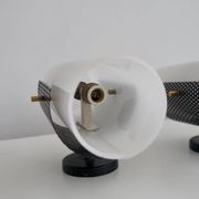 Set of four wall lights in white plexiglass and perforated black metal.