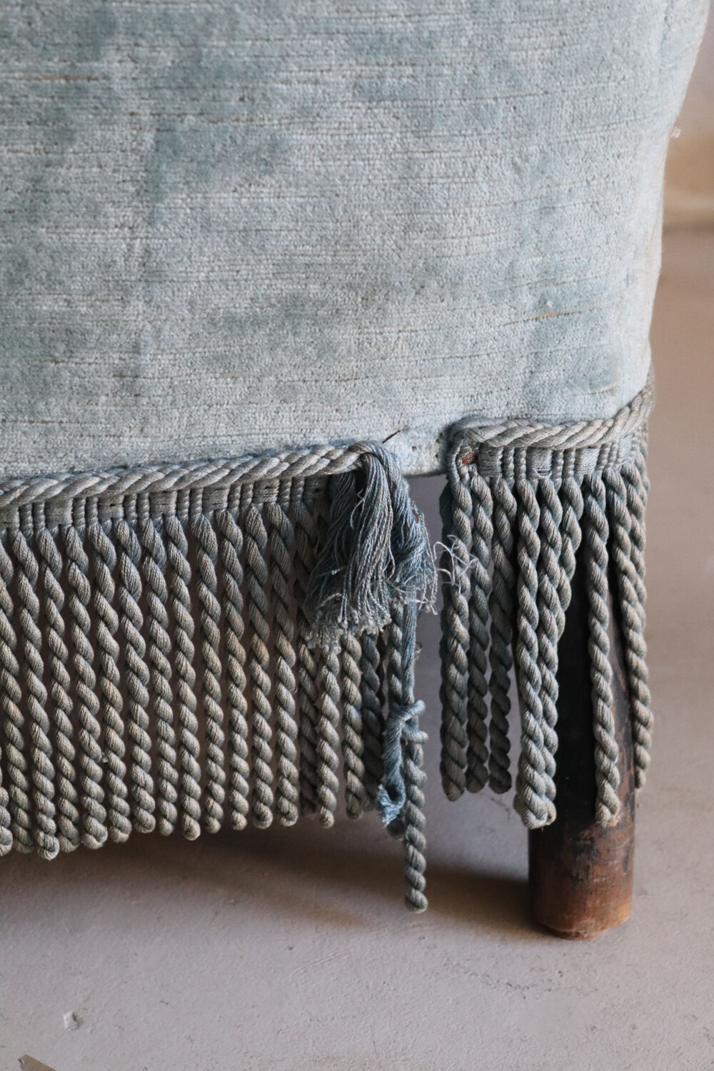 Vintage blue velvet fringed armchair.