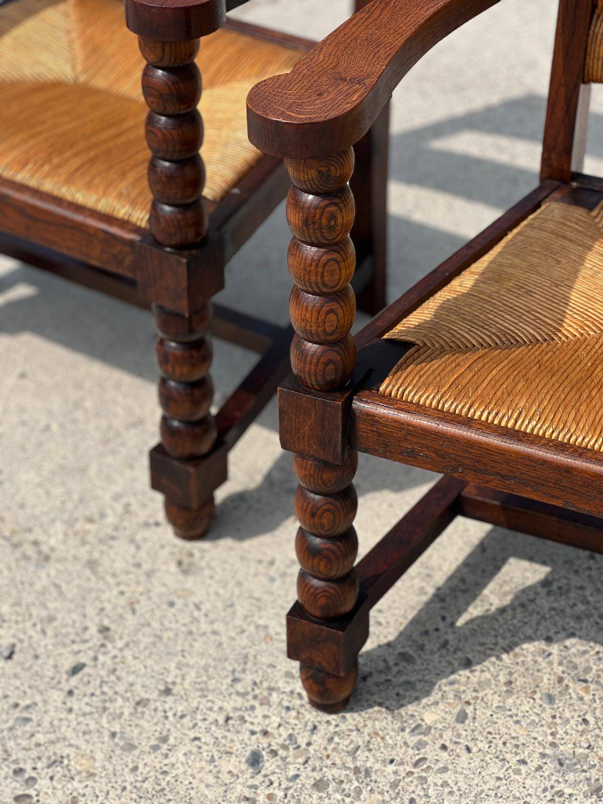 Pair of stained oak and straw armchairs, French work, 1950