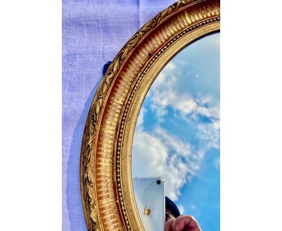 Oval wall mirror in gilded wood late nineteenth