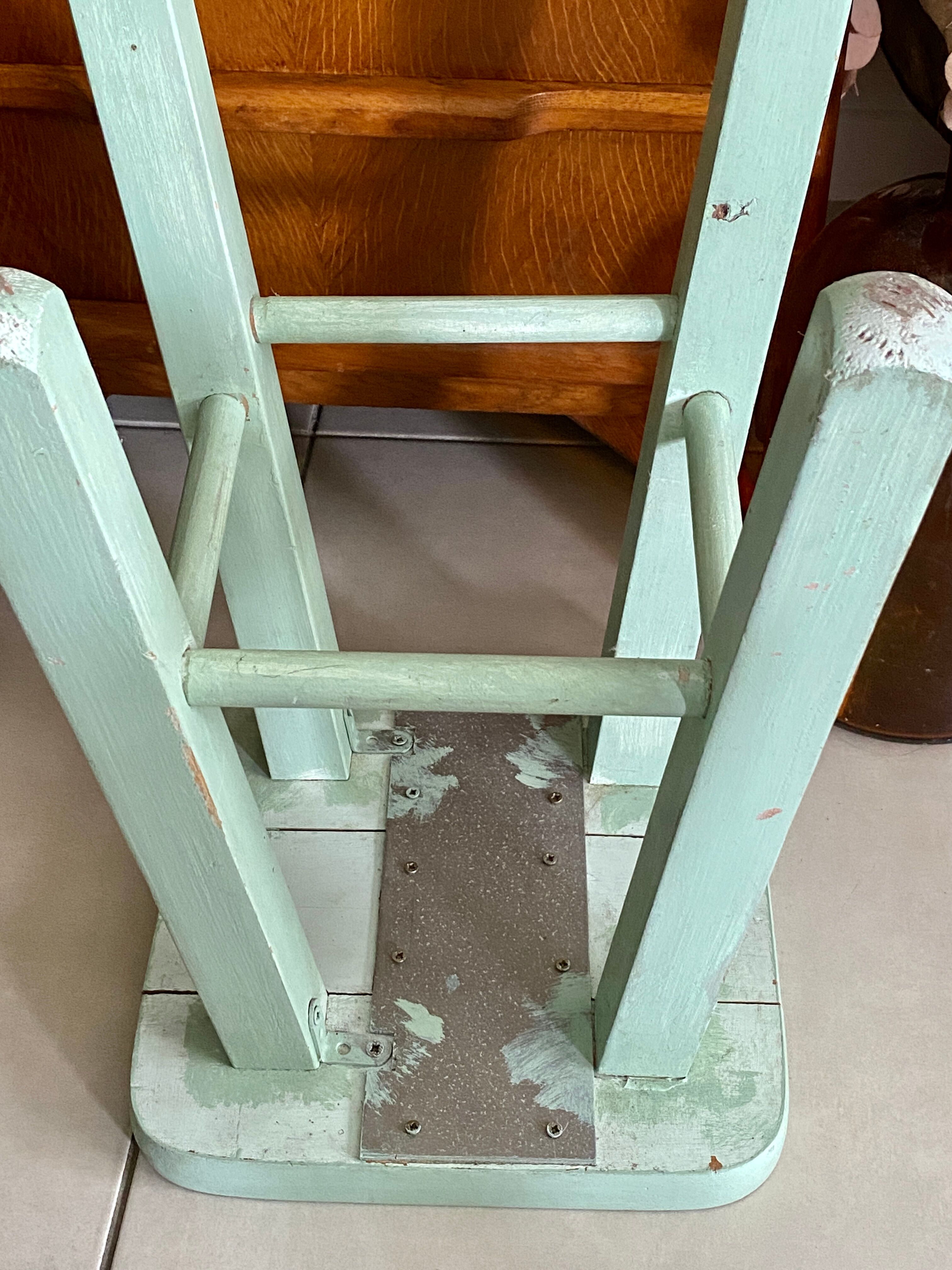 Old almond green wooden stool