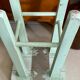 Old almond green wooden stool