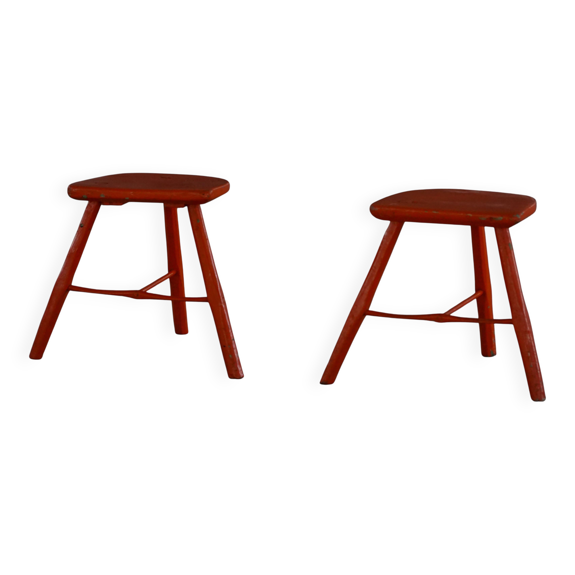 Pair of wooden stools painted in patinated red with flared legs, 1950s-1960s.