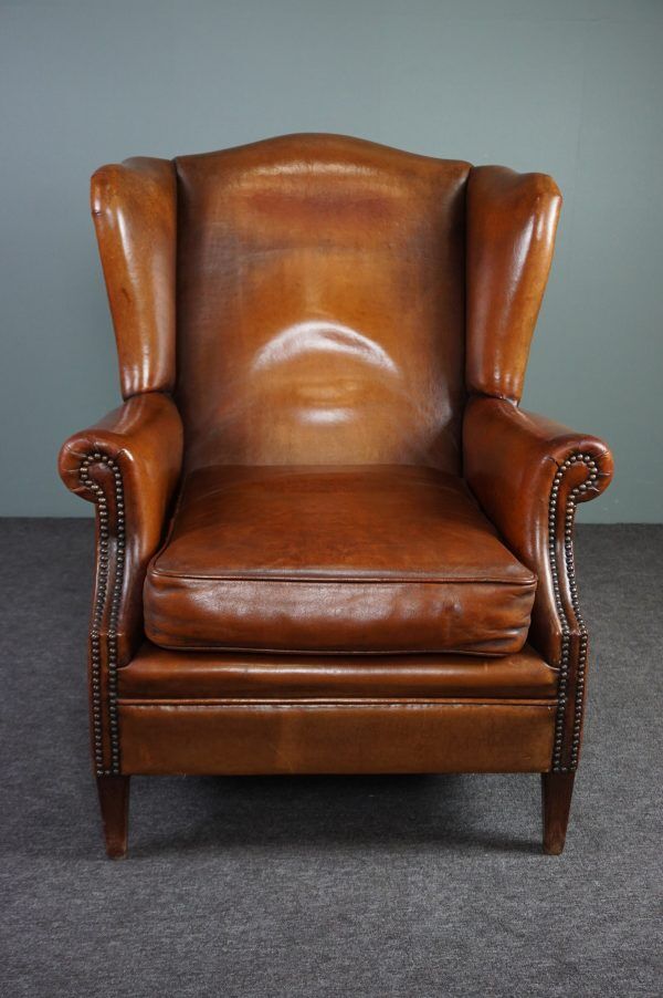 Eared armchair in patinated sheepskin