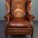 Eared armchair in patinated sheepskin