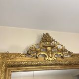 Antique Louis XVI style mirror in gilded wood