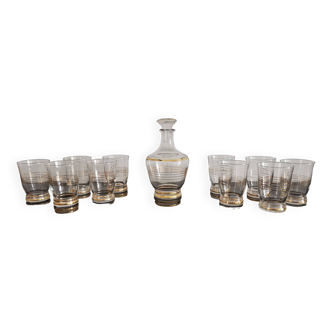 Old glass and gold-edged liquor service with its carafe and 10 vintage glasses