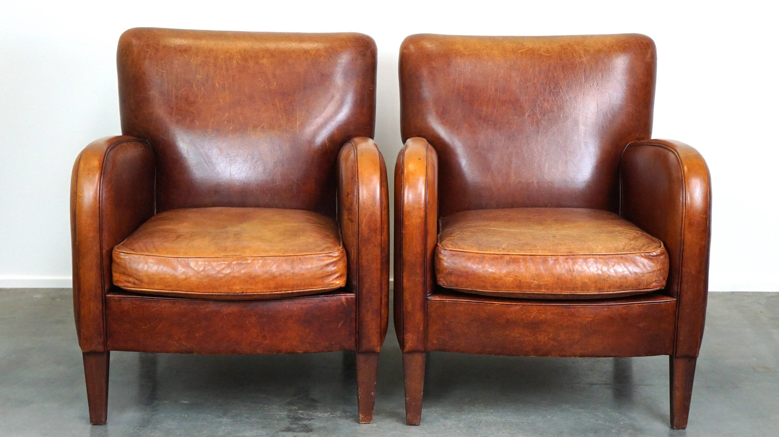 Set of 2 subtle sheepskin leather armchairs with a beautiful warm color scheme