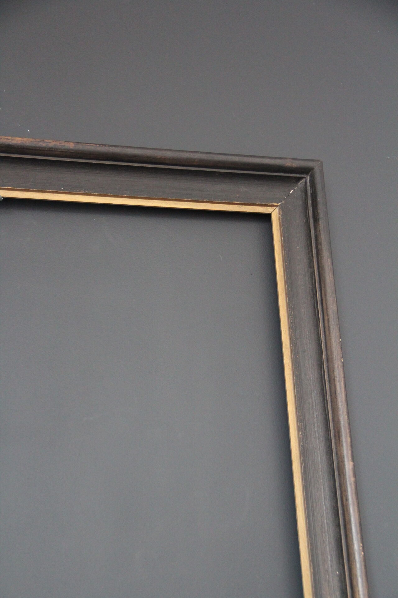 Large wooden black and gilded frame