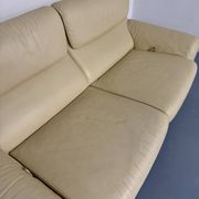 Two-seater designer sofa De Sede DS-2011 in cream leather with adjustable backrest.