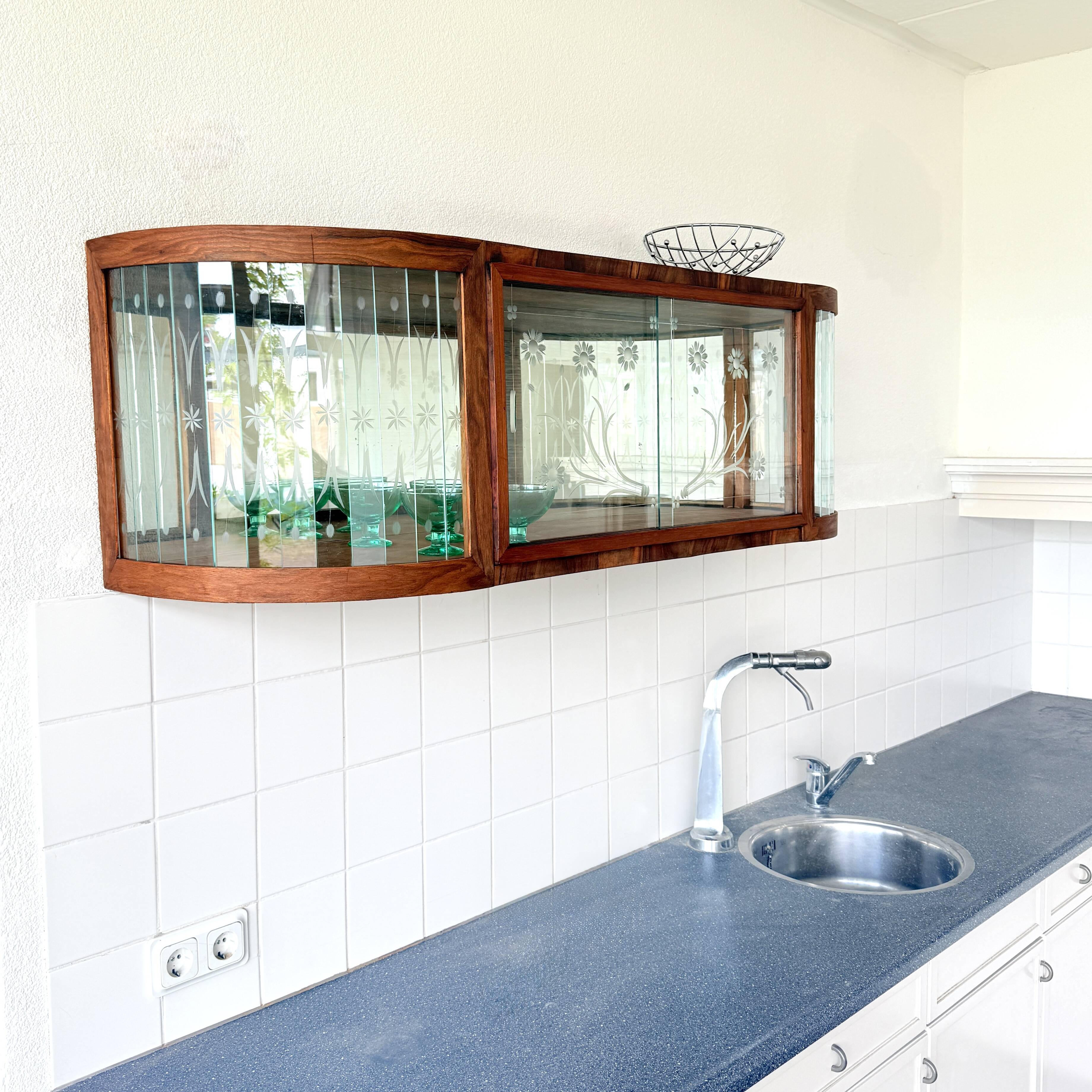 Art Deco-style wall-mounted display cabinet with floral engraving
