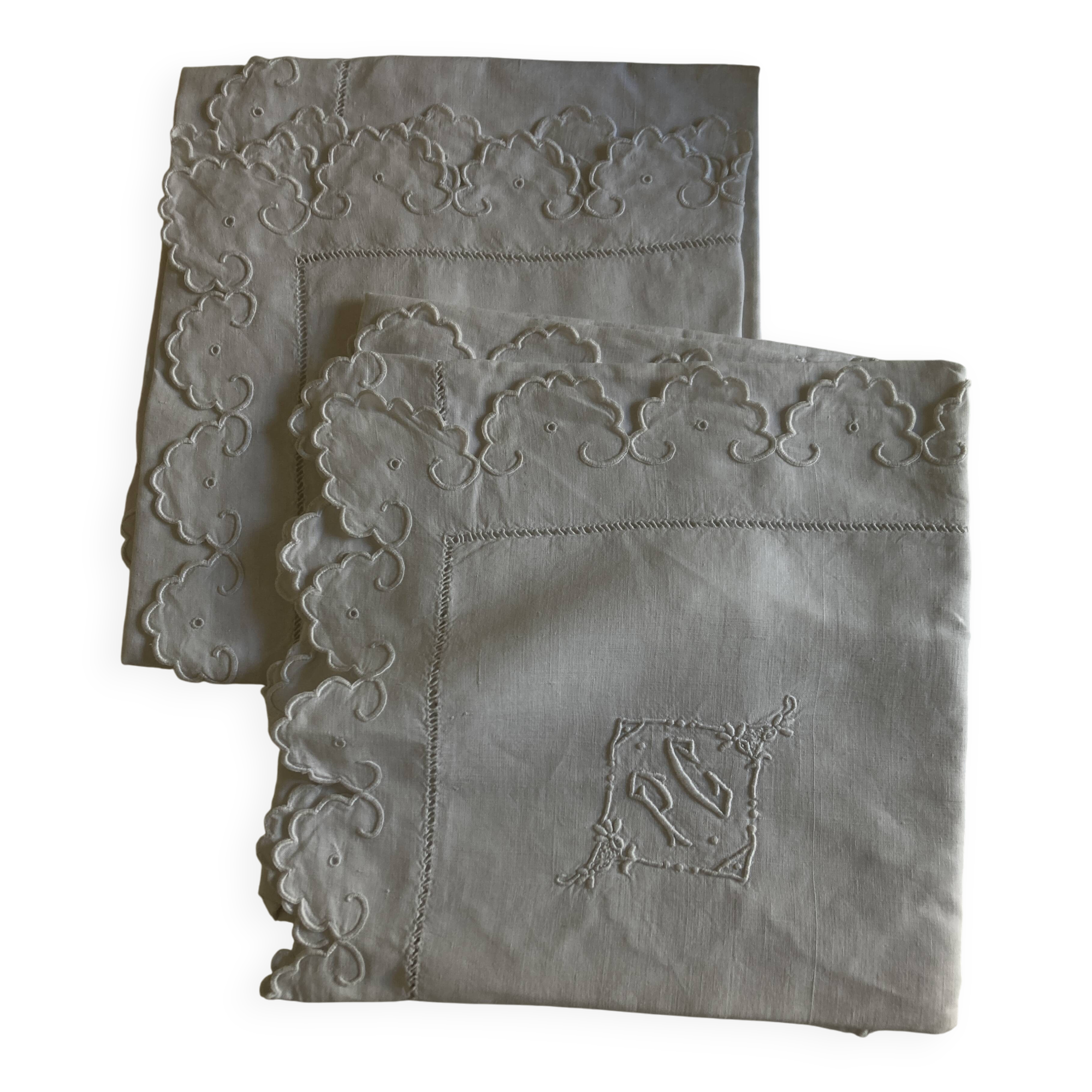 Pair of 19th century linen thread pillowcases embroidered with scallops