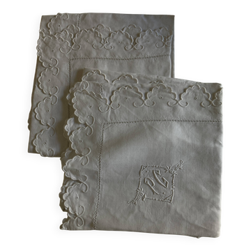 Pair of 19th-century linen pillowcases embroidered with scallops.